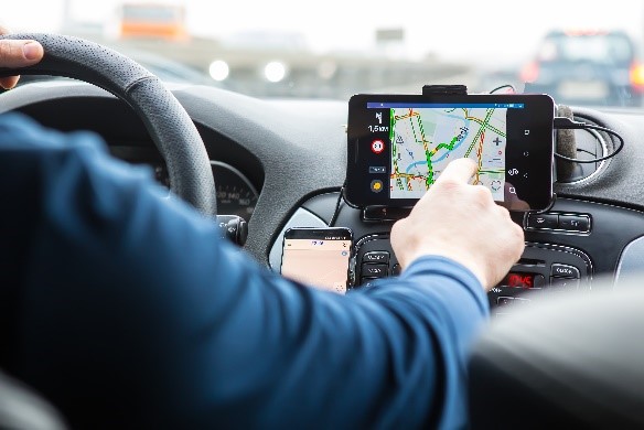 man using a gps unit in car